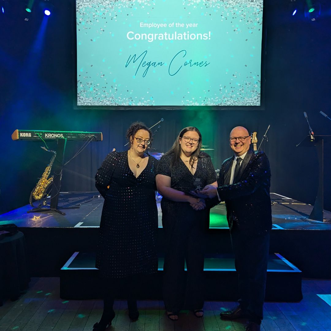 Megan Cornes receiving her award with Jon Marlow and Hayley Cockayne