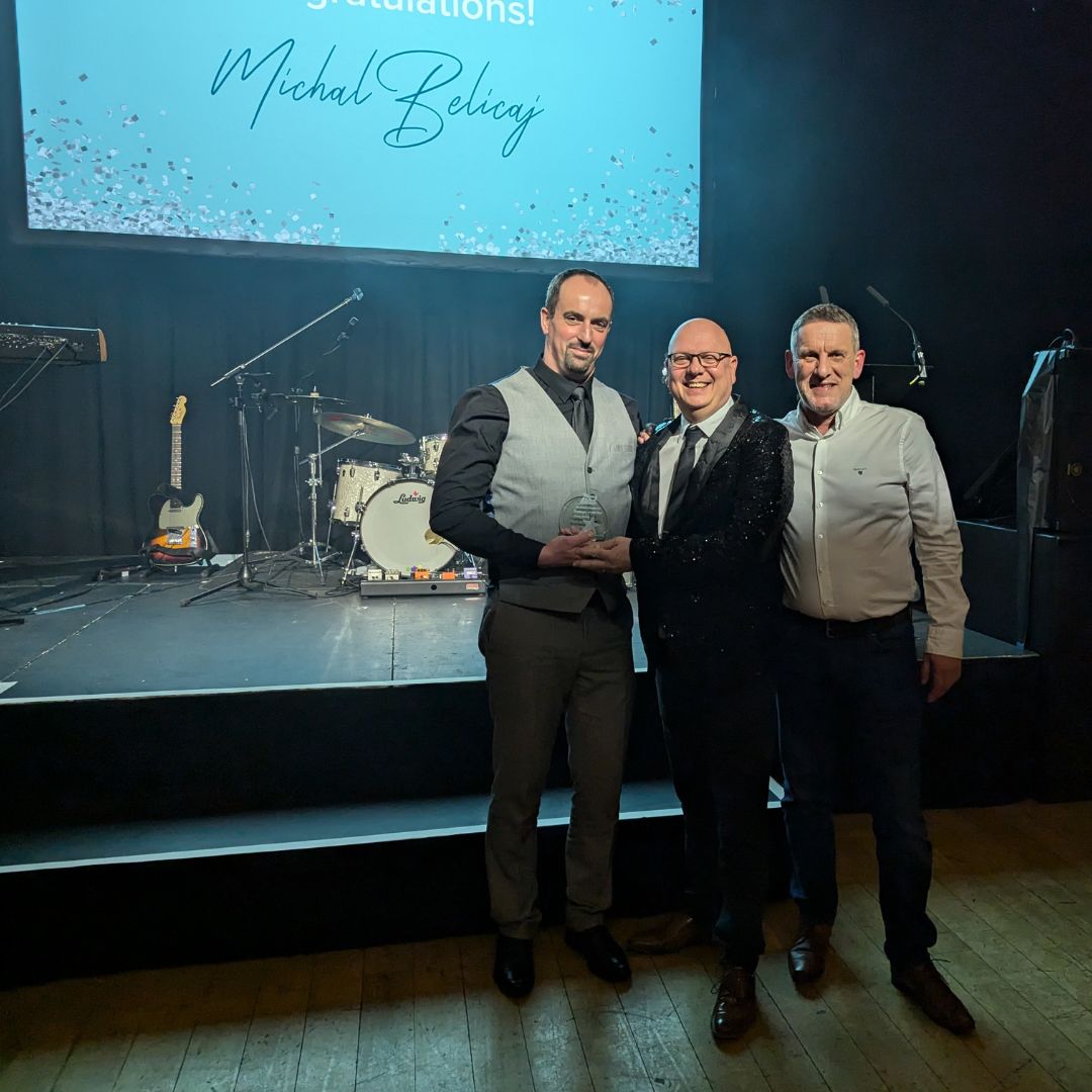 Michael Belicaj receiving his award with Jon Marlow and Paul Farrow